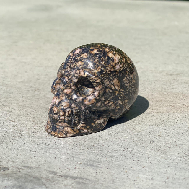 Natural Rhodonite Hand Carved Small Skull A - .24 lbs (2 x 1.25 x 1.5 inches) - Magick Magick.com